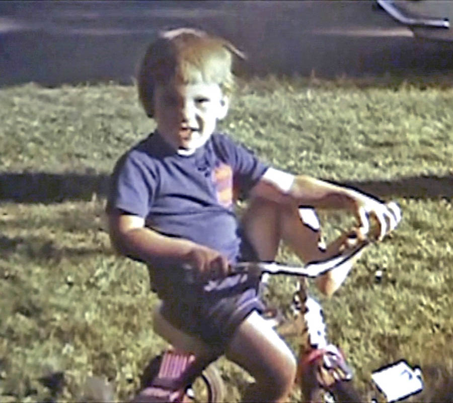 noah on trike in front yard