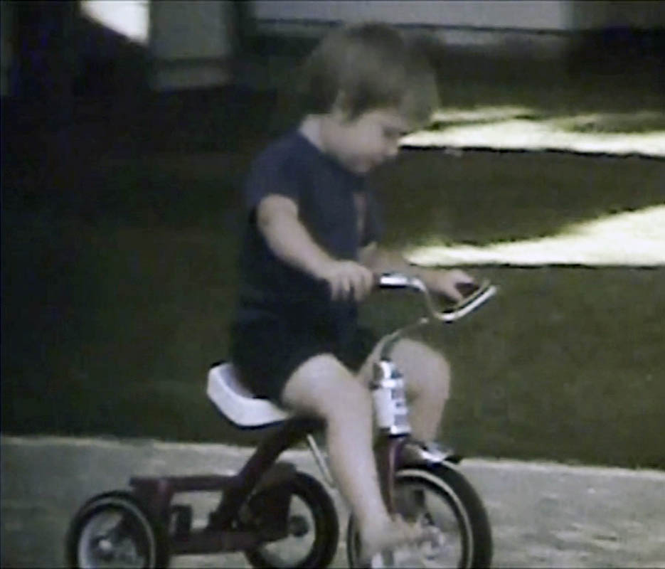 noah on trike in front yard