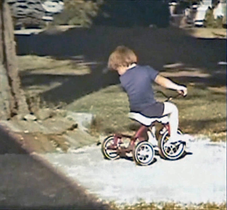 noah on trike in front yard