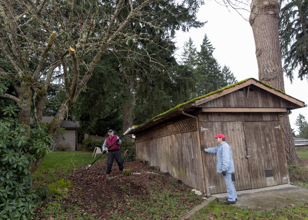 mike and jan trimming tree